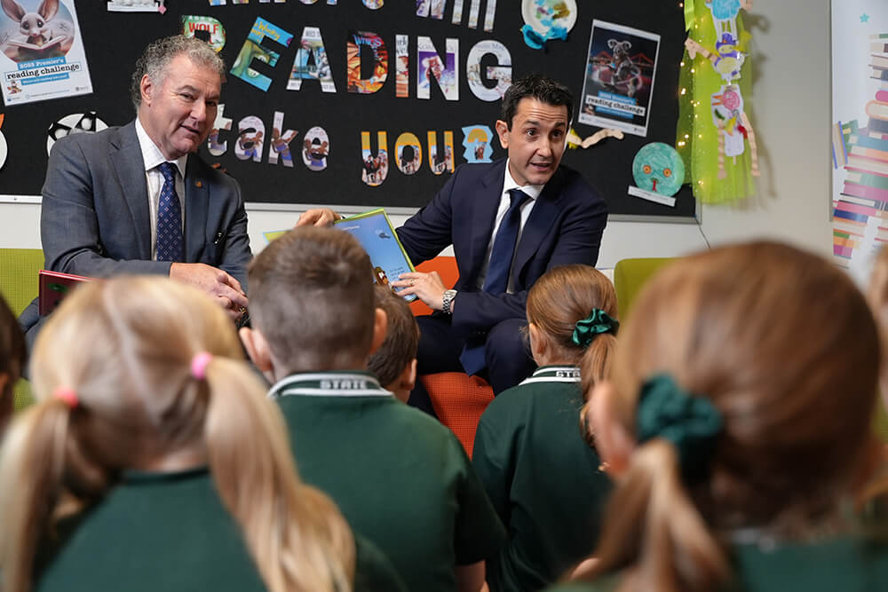 Premier David Crisafulli with students in a classroom